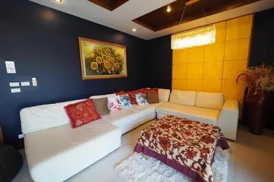 a living room with a couch and a table at 4Bedroom Villa with Private Pool in Ban Klang