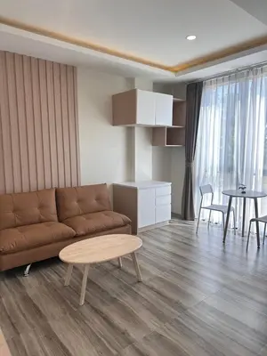 a living room with a couch and a table at Sleep At Airport in Nai Yang Beach