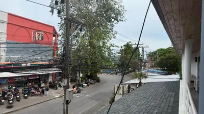 an overhead view of a street with motorcycles parked on the street at Chalong Paradise Guesthouse in Ban Bang Chak