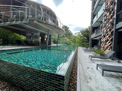 a swimming pool in the middle of a building at Emerald Terrace Condo 10-Family One Bed & Sofa Bed Garden View in Patong Beach