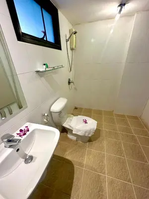 a bathroom with a white sink and a toilet at Theclickguesthouse in Ban Bang Chak
