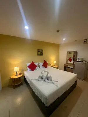 a bedroom with a bed with a heart decoration on it at Theclickguesthouse in Ban Bang Chak