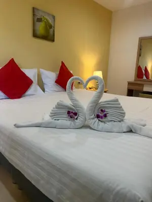 two swans made to look like hearts sitting on a bed at Theclickguesthouse in Ban Bang Chak