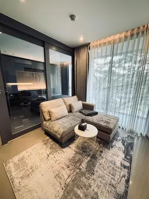 a living room with a couch and a table at Citygate Kamala Condo Paris in Kamala Beach