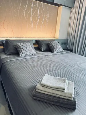 a bed with two towels sitting on top of it at Citygate Kamala Condo Paris in Kamala Beach