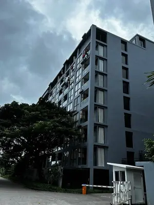 a tall white building with a lot of windows at Citygate Kamala Condo Paris in Kamala Beach