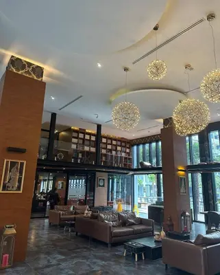 a large room with couches and chairs in a library at Citygate Kamala Condo Paris in Kamala Beach