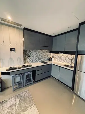 a kitchen with blue cabinets and a counter top at Citygate Kamala Condo Paris in Kamala Beach