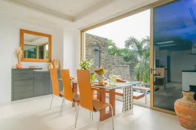 a dining room with a table and chairs at Seaview Villa Near Naithon Beach Phuket in Nai Thon Beach