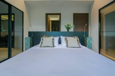 a bedroom with a large white bed with pillows at Seaview Villa Near Naithon Beach Phuket in Nai Thon Beach