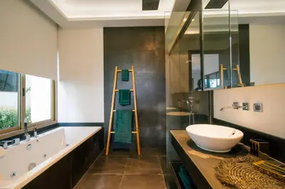 a bathroom with a large sink and a large mirror at Seaview Villa Near Naithon Beach Phuket in Nai Thon Beach
