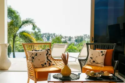 a group of chairs sitting on a porch with a table at Seaview Villa Near Naithon Beach Phuket in Nai Thon Beach