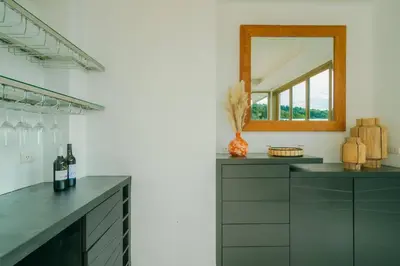 a kitchen with a mirror and a counter with wine bottles at Seaview Villa Near Naithon Beach Phuket in Nai Thon Beach