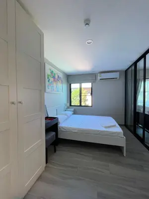 a bedroom with two beds and a window at The Title Residencies Naiyang in Phuket