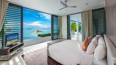 a living room with a tv and a large window at Ocean's 11 Villa in Thalang