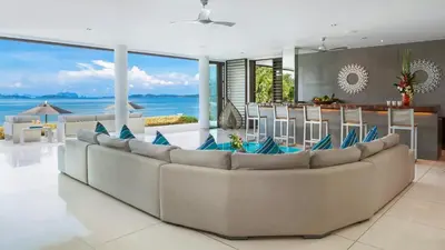 a living room with a couch and a view of the ocean at Ocean's 11 Villa in Thalang