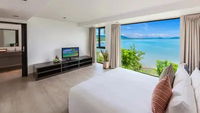 a bedroom with a large bed and a large window at Ocean's 11 Villa in Thalang