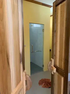a bathroom with a shower with a glass door at Thiwson Beach Resort - SHA Extra Plus in Ko Yao Yai