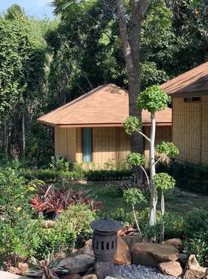 a house with a garden with a fountain in front of it at Thiwson Beach Resort - SHA Extra Plus in Ko Yao Yai