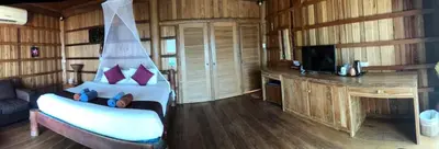 a bedroom with a bed and a tv in a room at Thiwson Beach Resort - SHA Extra Plus in Ko Yao Yai