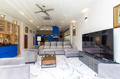 a living room with a couch and a table at Villa Valentine Phuket in Ban Thalat Choeng Thale
