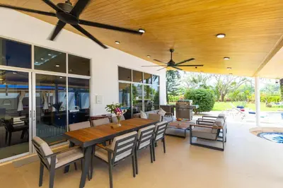 a dining room with a wooden table and chairs at Villa Valentine Phuket in Ban Thalat Choeng Thale