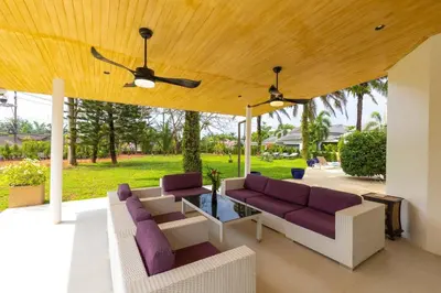 a patio with purple furniture under a wooden ceiling at Villa Valentine Phuket in Ban Thalat Choeng Thale