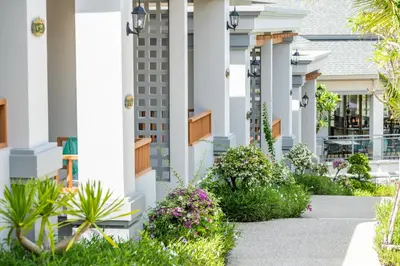a view of a building with plants and flowers at AZ Sunrise Resort & Fitness Club in Layan Beach