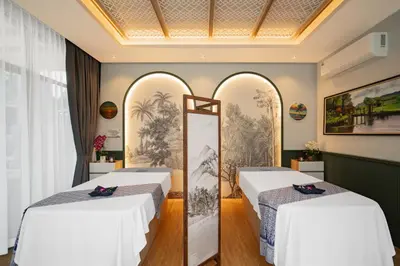 a hotel room with two beds and a mirror at AZ Sunrise Resort & Fitness Club in Layan Beach