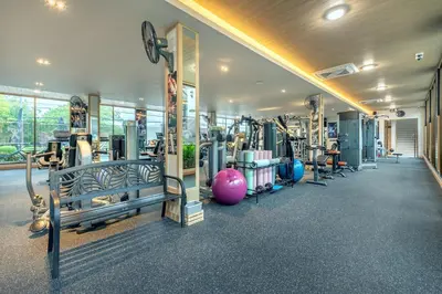 a gym with a bunch of treadmills and machines at AZ Sunrise Resort & Fitness Club in Layan Beach