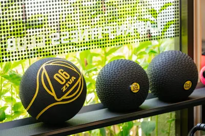 three golf balls sitting on a shelf in front of a window at AZ Sunrise Resort & Fitness Club in Layan Beach