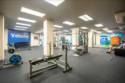 a gym with several machines and people in a room at Ark Studio only 10 Minutes from kataKaron Beach in Karon Beach
