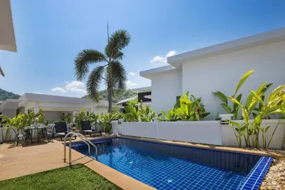 a swimming pool in the backyard of a house at Relaxing Holidays - 2BR Private Pool Villa Greens 8, Rawai in Rawai Beach