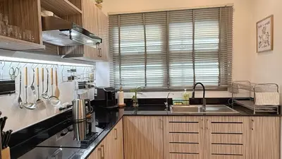 a kitchen with a sink and a counter top at Cozy family townhouse in Chalong