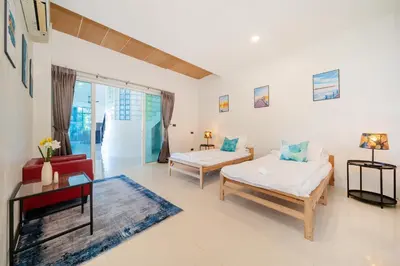 a living room with two beds and a couch at Patong Cliff Pool villa in Patong Beach