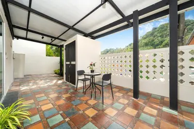 a patio with a table and chairs on a balcony at Patong Cliff Pool villa in Patong Beach