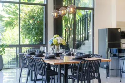 a dining room with a table and chairs at Patong Cliff Pool villa in Patong Beach