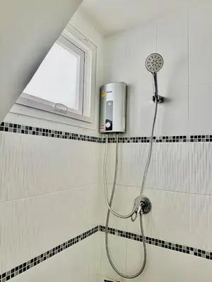 a shower with a shower head in a bathroom at Sirihouse at Supalai Bella Thalang Phuket in Phuket