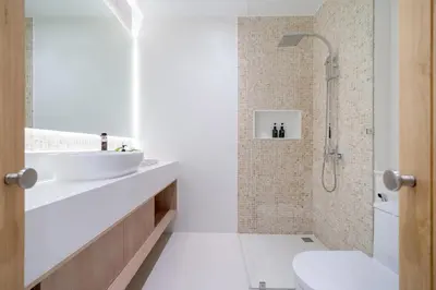 a white bathroom with a sink and a shower at Coco Villas Phuket - Private Pool Villas by Escape Villas in Thalang