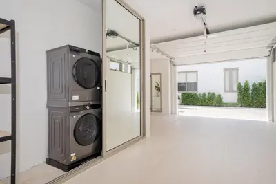 a living room with a large mirror and a television at Coco Villas Phuket - Private Pool Villas by Escape Villas in Thalang