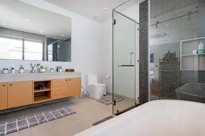 a bathroom with a tub and a glass shower at Bang Tao Botanica Modern Loft 4 bd S in Phuket