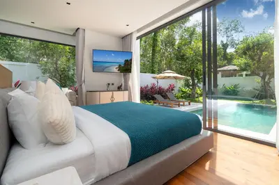 a bedroom with a large bed and a pool at Bang Tao Botanica Modern Loft 4 bd S in Phuket