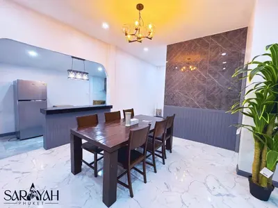 a kitchen and dining room with a wooden table and chairs at Sarayah Phuket 4Bed Villa in Ban Tha Rua