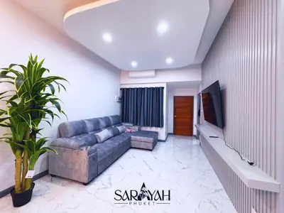 a living room with a couch and a tv at Sarayah Phuket 4Bed Villa in Ban Tha Rua