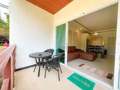 a balcony with a table and chairs on a house at Oasis 1 Bedroom Apartment In Rawai in Phuket Town