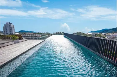 a view of a pool of water on a bridge at Patong rooftop Pool luxury Condo with Bathtub and sofa bed big balcony in Patong Beach