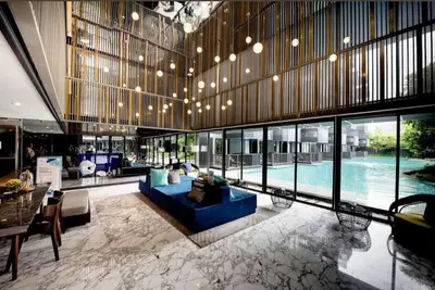a large lobby with a blue couch and a pool at Patong rooftop Pool luxury Condo with Bathtub and sofa bed big balcony in Patong Beach