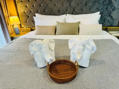a bed with white socks and a basket on it at Patong rooftop Pool luxury Condo with Bathtub and sofa bed big balcony in Patong Beach
