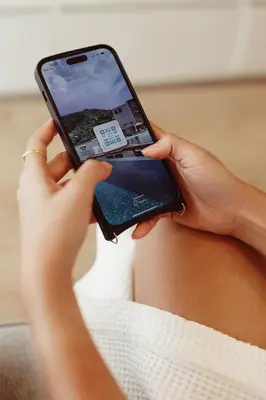 a person holding a cell phone in their hand at Palmetto Park Residence in Karon Beach