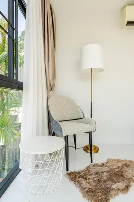 a living room with a chair and a lamp at Sunny Stay A8 Charming Residence Close to Nature in Kamala Beach